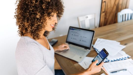 employee working at a desk thinking about financial wellbeing