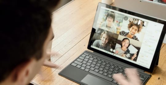 Man talking to his remote team members on a video call