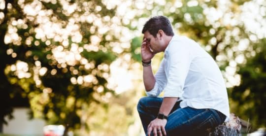 Stressed man sitting outside having a breakdown