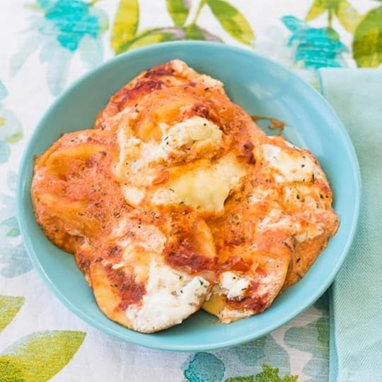 Cheesy crock pot ravioli served in a blue bowl.