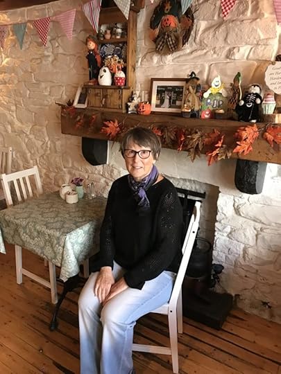 Image of the author, Martha Geaney, sitting inside at Curry's Cottage