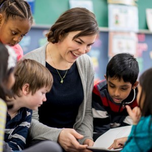 Teacher surrounded by students read books