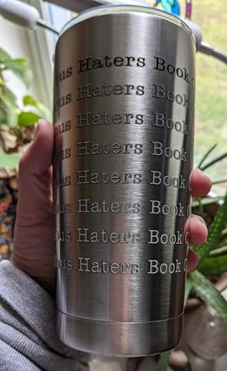 my hand holding a stainless steel tumbler with the words 