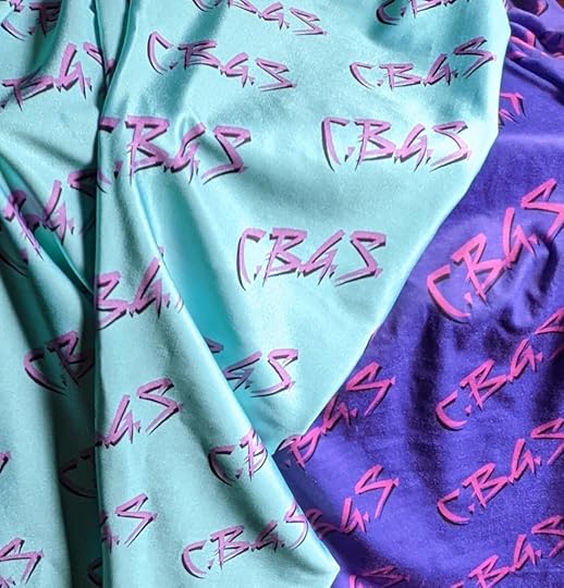 bright turquoise fabric over purple fabric. Both pieces have 
