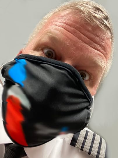 Cap'n Aux wearing a Covid Mask while flying