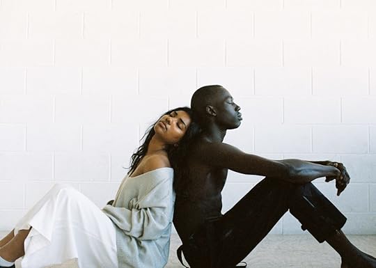 black man and woman leaning on one another