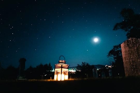 A candelit lantern below the moon on a Haunted Lunenburg Walking Tour
