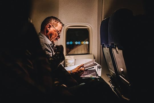 Man reading on night flight
