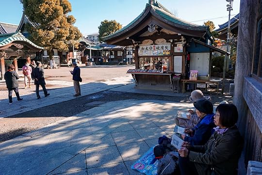 Women painting outside Taishakuten Daikyoji Temple in Tokyo