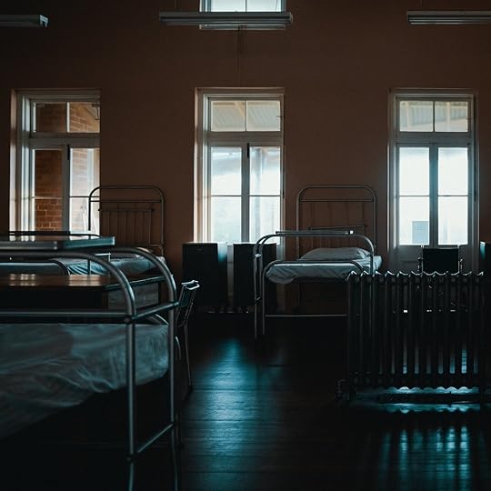 Empty beds in a dorm (Image via Unsplash)