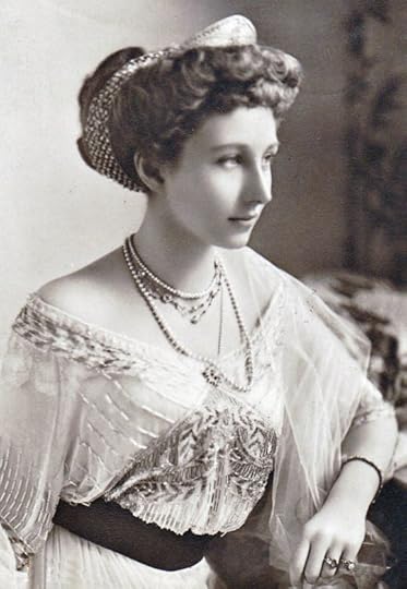 Black and white photo of Princess Viktoria wearing a beaded and embroidered gown, several necklaces and rings. 