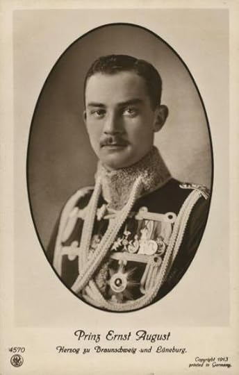 Black and white photo dated 1913 of Prince Ernst August dressed in a military tunic adorned with medals, orders and aiguillettes.