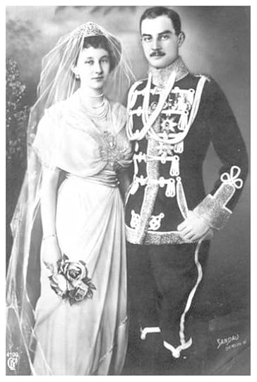 Black and white photo of the princess dressed in white gown, multi-strand pearl necklace, and tiara with veil; and the prince, dressed in military uniform with frogging, aiguillettes, medals and orders on the tunic.