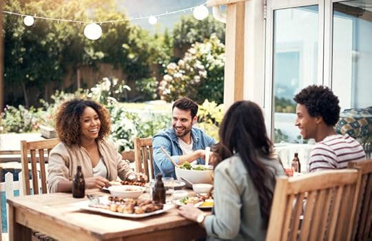 Group of friends having a meal together outdoors