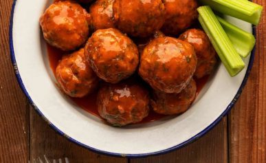 A plate of Buffalo meatballs with blue cheese sauce.