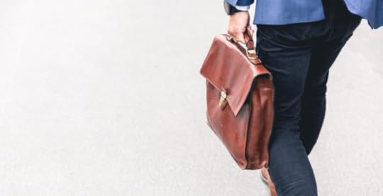 Employee with brief case walking to return to office
