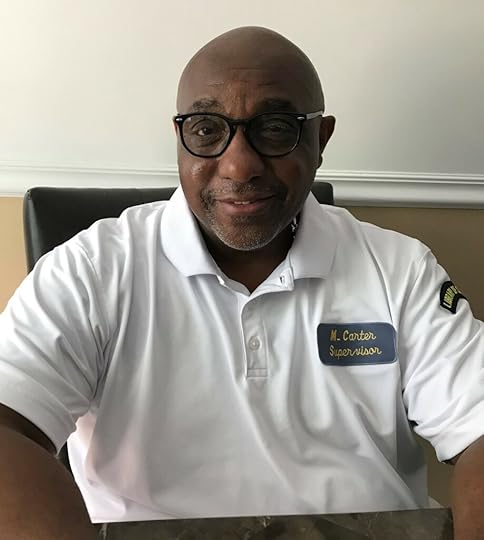 maurice carter wearing glasses seated at his desk