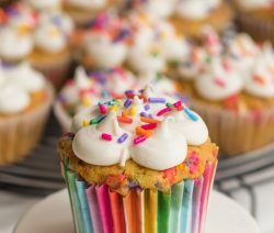 Small Cake Stand With Colorful Sprinkled topped Funfetti Cupcake, other similar cupcakes in the background