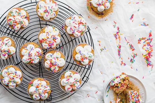 Cooling Rack with Colorful Funfetti Cupcakes on Top , on a white marble surface