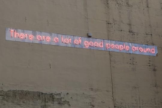 Image: art installation on the side of a building, made of neon letters spelling the sentence 