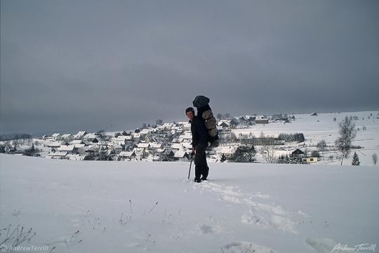 hiker andrew terrill approaching village in winter landscape austria