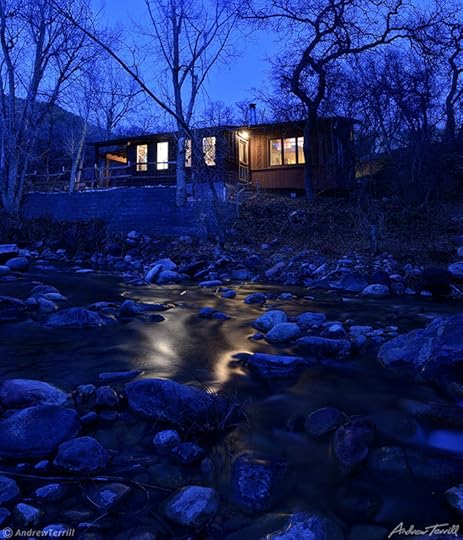 a cabin by a creek in colorado at night