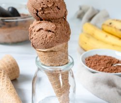 Cone with two banana chocolate ice cream scoops inside a jar