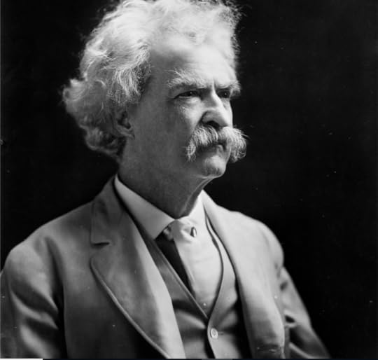 Mark Twain wearing a white three piece suit, with bushy white mustache and tousled hair.