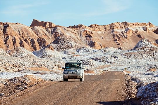 SAN PEDRO DE ATACAMA, CHILE - NOVEMBER 24, 2013: Unidentified people drive car in Valle de la Luna in San Pedro de Atacama, Chile., Atacama Desert