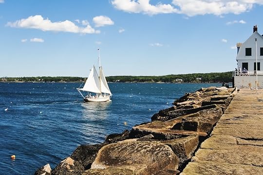 Beautiful view of Rock paved path to Rockland breakwater lighthouse and sailing boat in Rockland harbor Maine usa, August travel