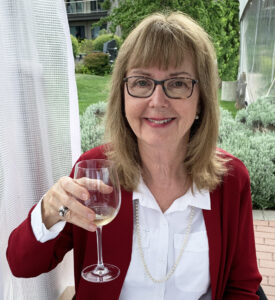 Author Elinor Florence holds wine glass