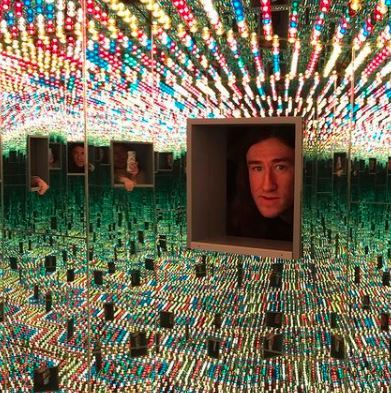 Daniel Bailey's face inside a box at Kusama's Infinity Mirrors art exhibit.