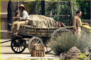 Halle Bailey as Ariel hiding in the back of a wagon