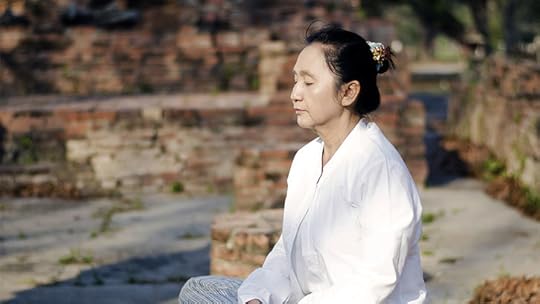 middle aged Asian woman meditating