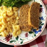meatloaf on plate with side dishes.