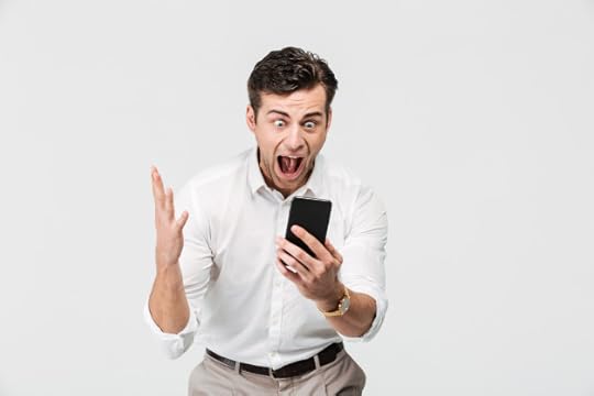 Free Photo | Portrait of a cheery happy man looking at mobile phone