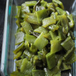 chopped and roasted poblano chiles in a glass dish.