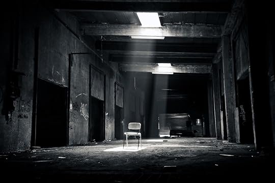 One lone chair sits in a dark and filthy, abandoned garage. Sunlight continues to stream in through the broken skylights. This is where I'm supposed to meet Patrick from high school.