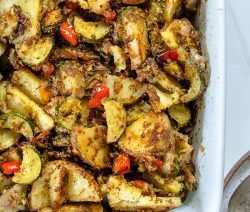zucchini potato casserole in a white baking pan