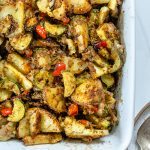 zucchini potato casserole in a white baking pan