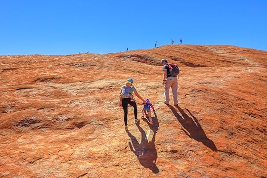 Uluru, Northern Territory, Australia - Aug 23, 2019: family with children climbing on the top of Uluru before October 2019 when the climb will be closed. Uluru - Kata Tjuta is sacred for Anangu people, The Red Centre Way