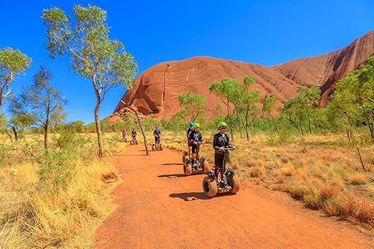 Uluru, Northern Territory, Australia - Aug 24, 2019: people visit Ayers Rock with Uluru Segway Tours along Uluru Base Walk in sand path of Uluru-Kata Tjuta National Park. Outdoors activity., The Red Centre Way