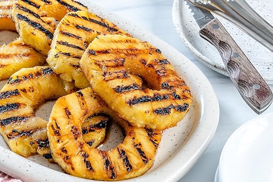 sliced grilled pineapples on a white tray in a white background