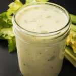 mason jar of cream of celery soup next to ribs of celery.