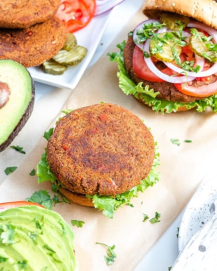 Southwest Black Bean Burger with various ingredients in a background