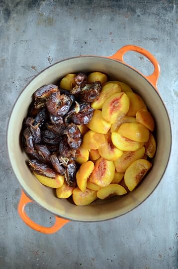 Pitted dates and peeled peaches in an orange pot.