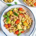 white plate of pasta with veggies