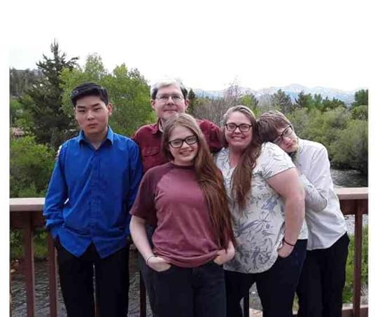 A family photo taken on a balcony in front of the Fraser river. 