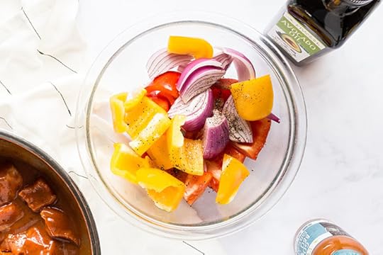 peppers and onion in a bowl for pork pineapple kebabs
