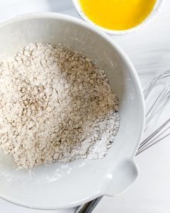 plum crisp ingredients in white bowl in white background